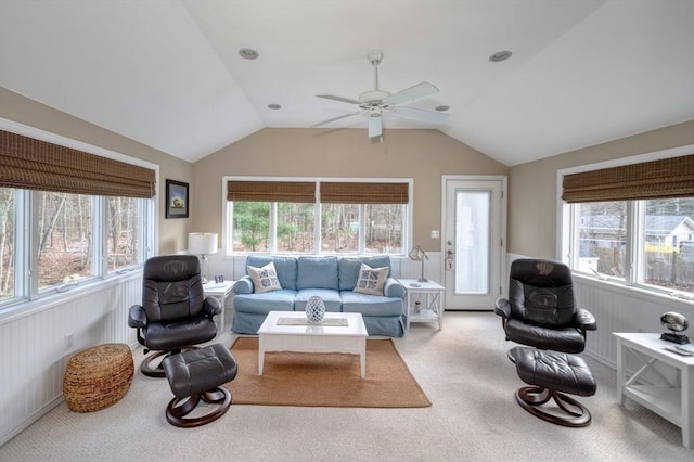 carpeted living room featuring ceiling fan, a wealth of natural light, and vaulted ceiling