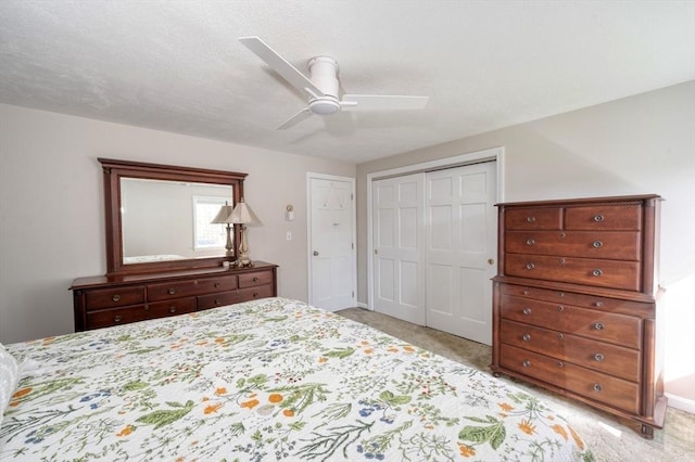 bedroom featuring ceiling fan, light colored carpet, and a closet