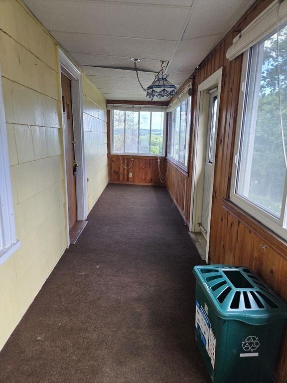 26 Kendig, Worcester, MA 01610 - unfurnished sunroom featuring wood walls and carpet