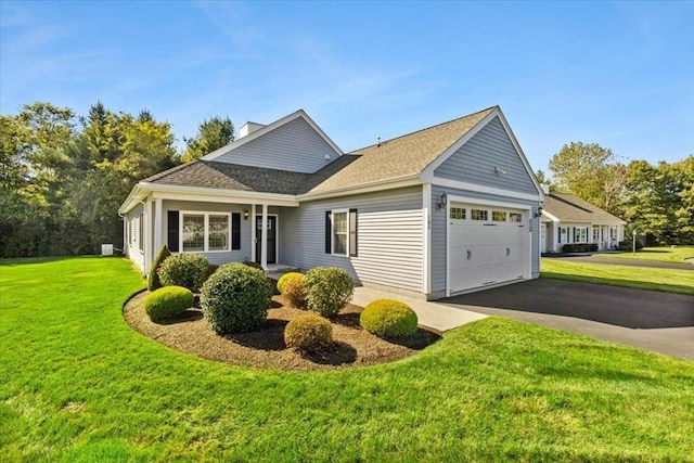 view of side of home featuring a yard and a garage