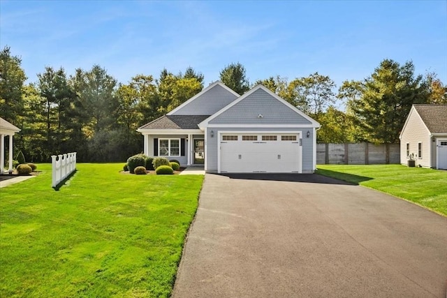 view of front of property featuring a garage and a front yard