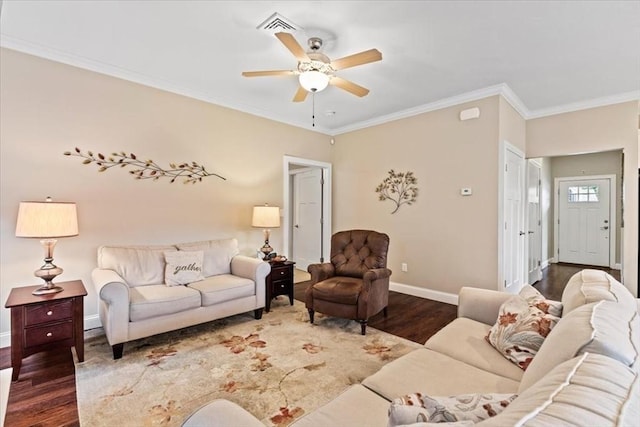 living room with dark hardwood / wood-style flooring, ornamental molding, and ceiling fan