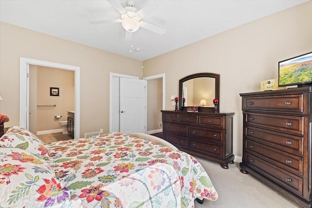 carpeted bedroom with connected bathroom and ceiling fan