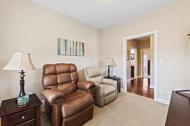 sitting room with light colored carpet