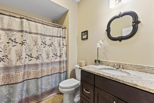 bathroom featuring vanity, tile patterned floors, and toilet