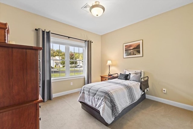 bedroom featuring light carpet