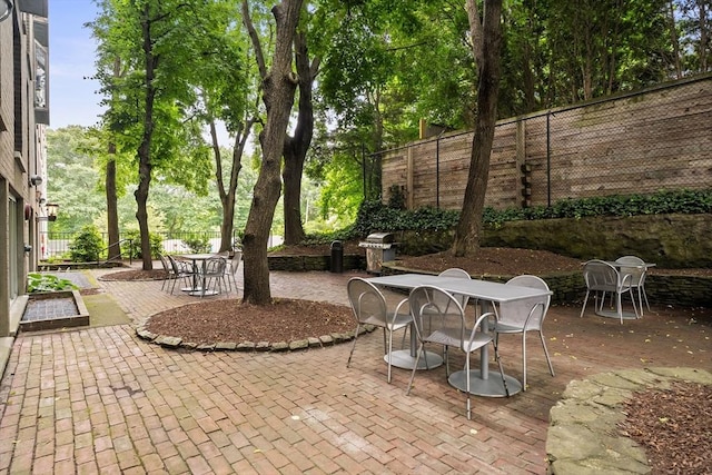99 Pond Ave Unit 220, Brookline, MA 02445 - fenced backyard featuring a patio area and outdoor dining space