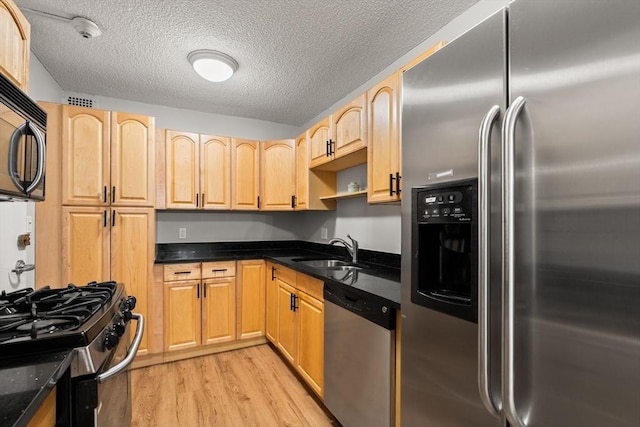 99 Pond Ave Unit 220, Brookline, MA 02445 - kitchen with appliances with stainless steel finishes, light brown cabinetry, light wood-style floors, a textured ceiling, and open shelves
