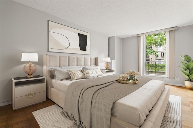 99 Pond Ave Unit 220, Brookline, MA 02445 - bedroom featuring a textured ceiling and baseboards
