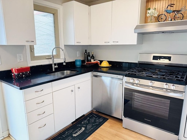 kitchen with white cabinets, ventilation hood, stainless steel appliances, light wood-type flooring, and a sink