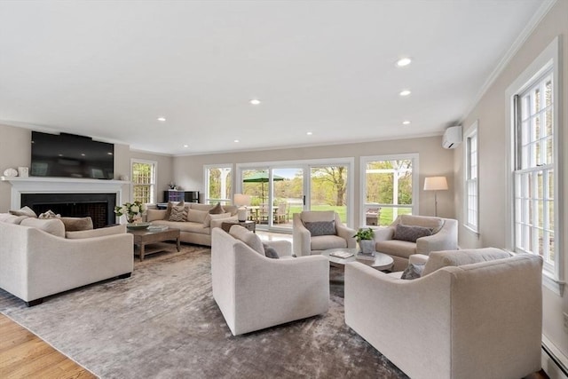 894 Great Pond Rd, North Andover, MA 01845 - living room featuring ornamental molding, a wall unit AC, a fireplace, recessed lighting, and wood finished floors