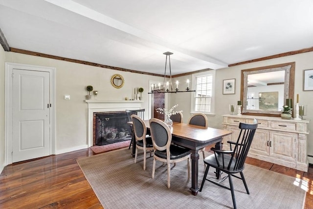 894 Great Pond Rd, North Andover, MA 01845 - dining room with dark wood-style floors, a fireplace with raised hearth, a chandelier, baseboards, and crown molding