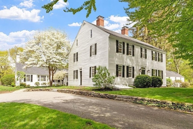 894 Great Pond Rd, North Andover, MA 01845 - view of front of house featuring a chimney and a front yard