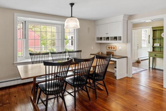 894 Great Pond Rd, North Andover, MA 01845 - dining room with a baseboard heating unit and dark wood-style flooring