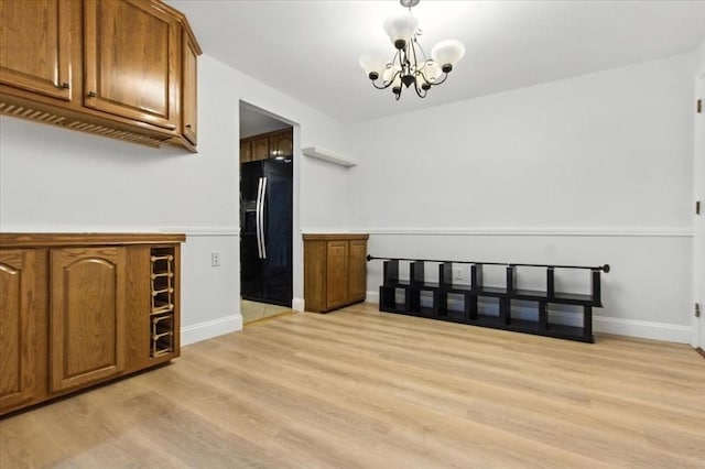 386 Great Rd Unit A3, Acton, MA 01720 - unfurnished dining area with light wood-type flooring and a chandelier