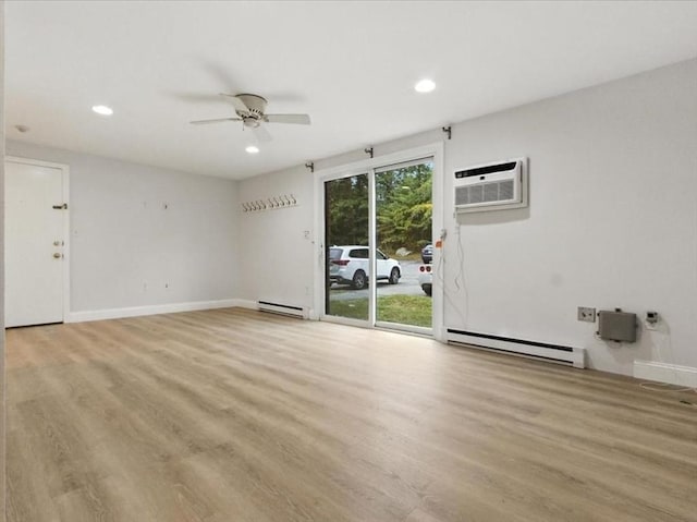 386 Great Rd Unit A3, Acton, MA 01720 - unfurnished living room with a baseboard radiator, a wall mounted air conditioner, a ceiling fan, light wood finished floors, and recessed lighting