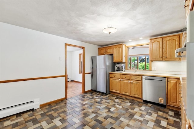 kitchen featuring stainless steel appliances, a baseboard radiator, a sink, light countertops, and baseboards