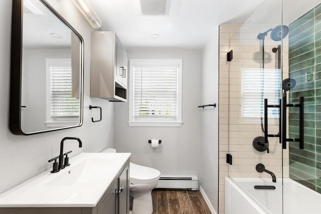full bathroom featuring a baseboard radiator, wood finished floors, vanity, toilet, and bathing tub / shower combination