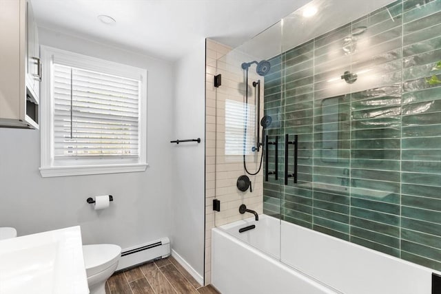 full bath with a baseboard radiator, toilet, wood finished floors, bathing tub / shower combination, and baseboards