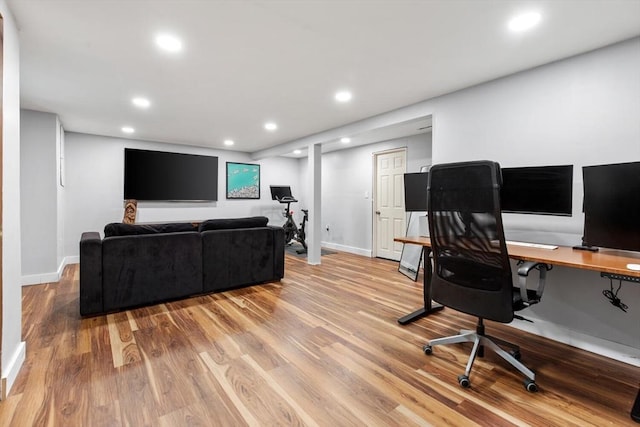 office featuring light wood finished floors, baseboards, and recessed lighting