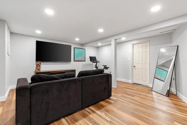 living area featuring light wood-type flooring, baseboards, and recessed lighting