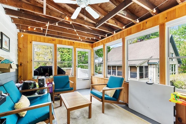 sunroom featuring ceiling fan and beam ceiling
