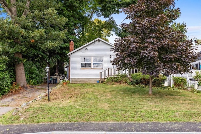 view of side of property with a yard