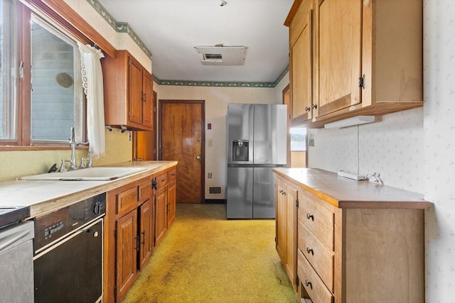 kitchen featuring stainless steel fridge, dishwasher, and sink