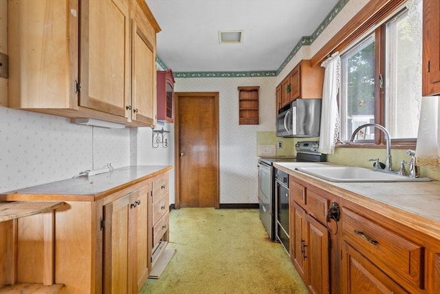 kitchen with appliances with stainless steel finishes and sink