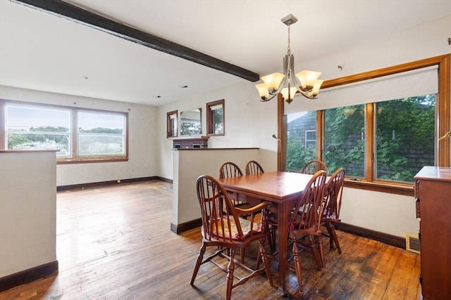 dining room with hardwood / wood-style flooring, beam ceiling, and a notable chandelier