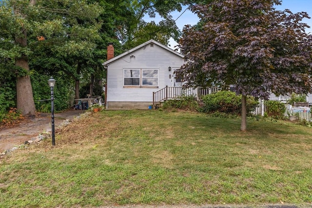 view of side of property with a lawn