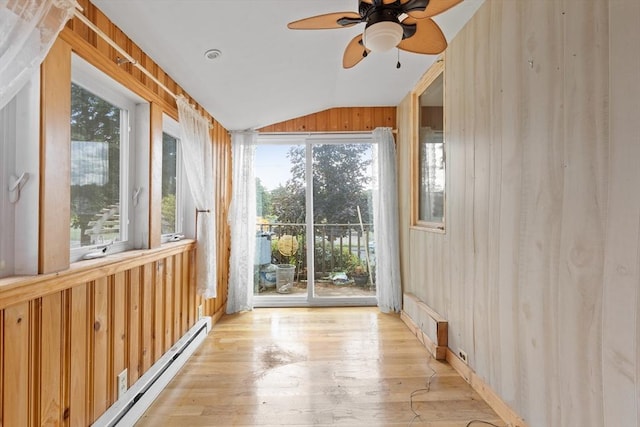 unfurnished sunroom with vaulted ceiling, ceiling fan, and baseboard heating