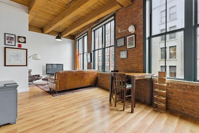 49 Melcher St Unit 405, Boston, MA 02110 - living area featuring wooden ceiling with exposed beams, wood finished floors, and brick wall