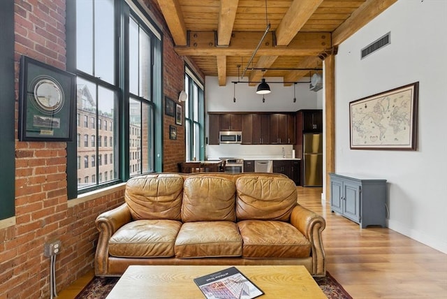 49 Melcher St Unit 405, Boston, MA 02110 - living area with wood ceiling with exposed beams, light wood-type flooring, brick wall, and baseboards