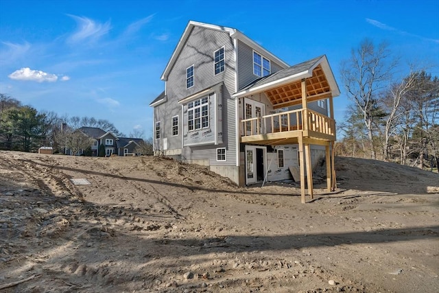 rear view of property with a wooden deck