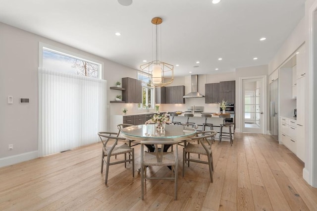 dining room with baseboards, recessed lighting, and light wood-style floors