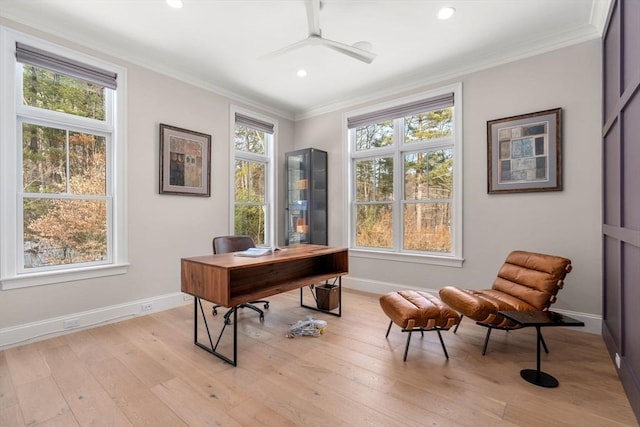 home office featuring baseboards, crown molding, and light wood finished floors