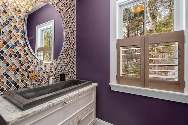 details featuring a sink, baseboards, and backsplash