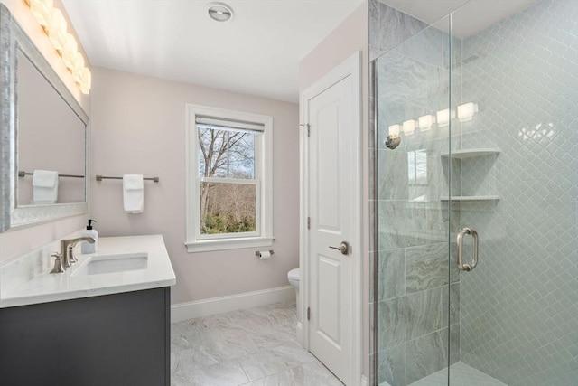 full bath with marble finish floor, toilet, vanity, a shower stall, and baseboards