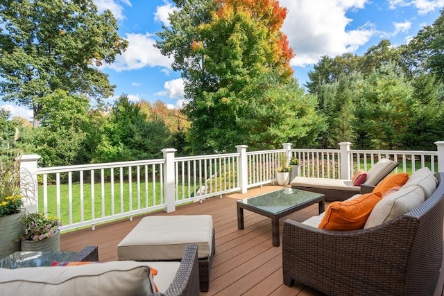 wooden terrace with an outdoor hangout area and a yard