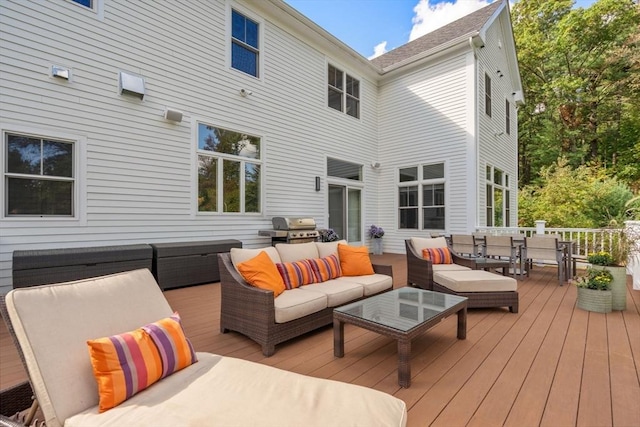 wooden deck with outdoor dining space, an outdoor living space, and grilling area