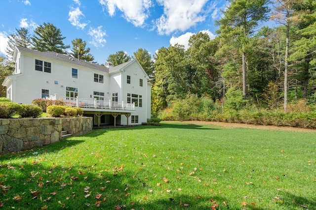 back of house with a lawn and a deck