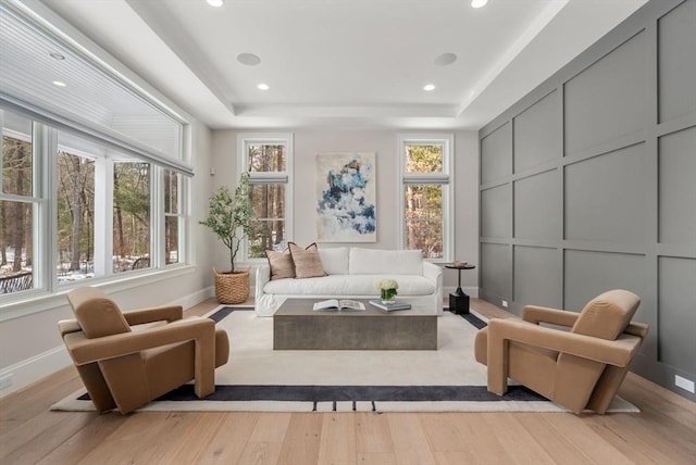 interior space with a raised ceiling and a wealth of natural light