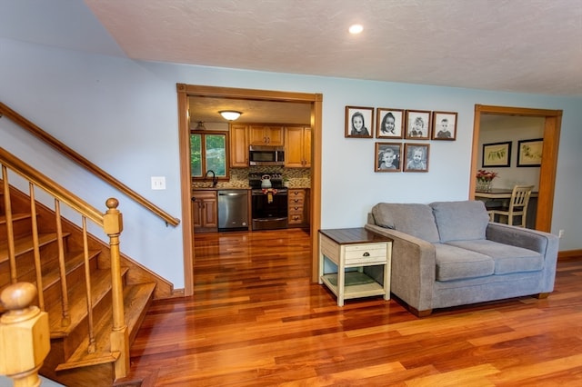 living room featuring sink and hardwood / wood-style flooring