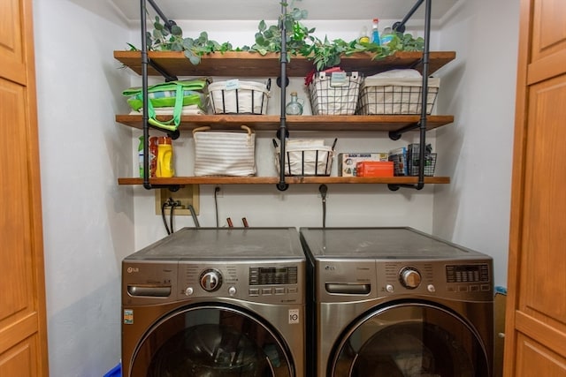 laundry room with washing machine and clothes dryer