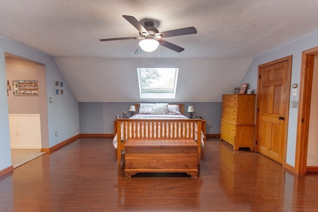 bedroom featuring lofted ceiling with skylight, ceiling fan, and wood-type flooring