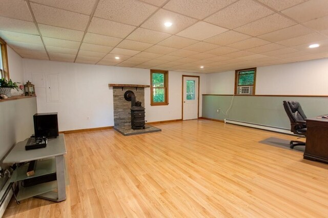 kitchen featuring white cabinets, baseboard heating, and light colored carpet