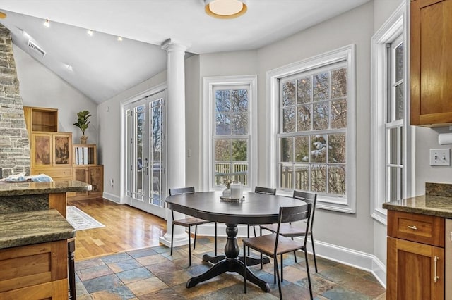 dining room with plenty of natural light and ornate columns