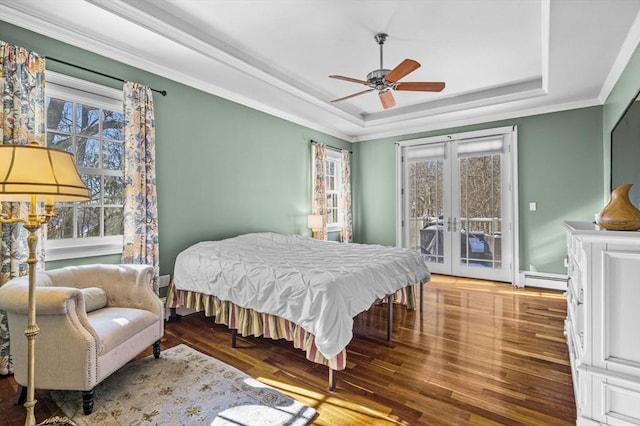 bedroom featuring multiple windows, access to exterior, ceiling fan, a tray ceiling, and french doors