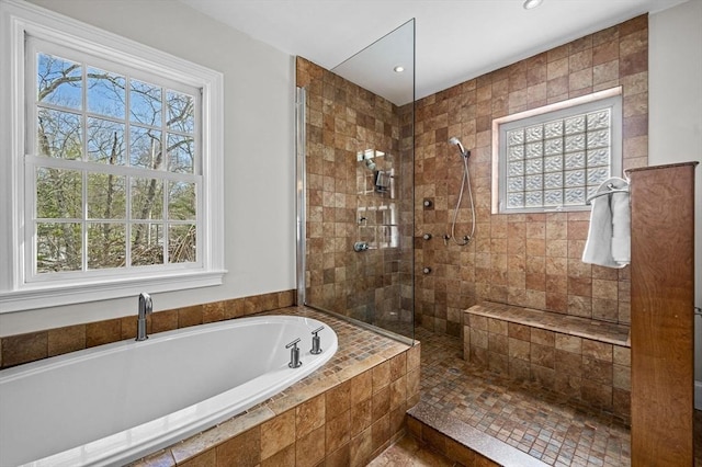 bathroom featuring separate shower and tub